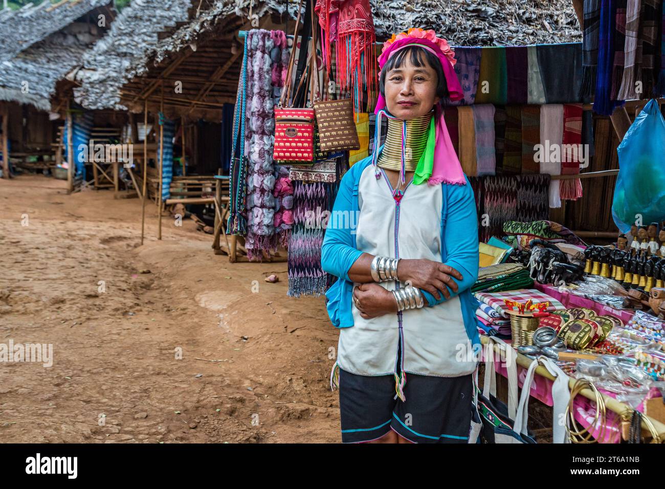 Woman selling woven scarves and other crafts in the Long Neck Karen tribe (Kayah Lahwi tribe) area of the Union of Hill tribes in Chiang Rai, Thailand Stock Photo