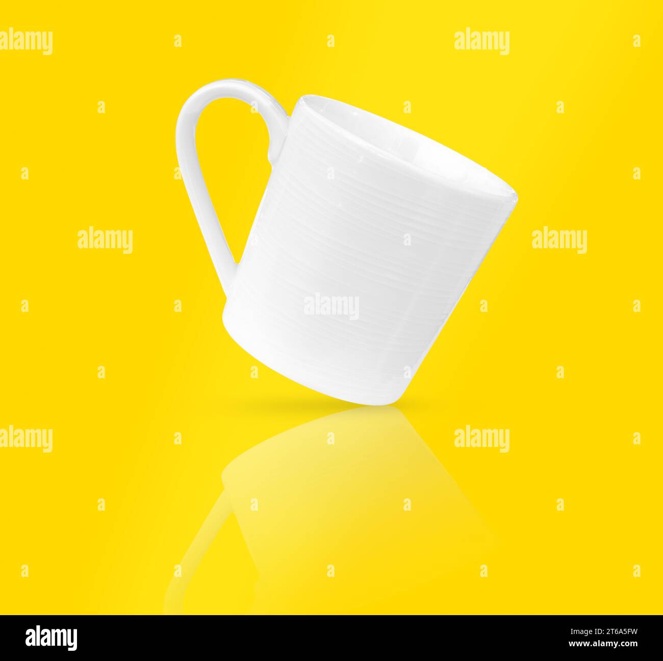 White coffee cup on yellow background, soft focus. Stock Photo