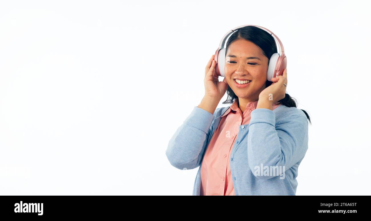 Headphones, happy or woman in listening to music, playlist or podcast for entertainment. Smile, asian female and relax to stream a song, online radio Stock Photo