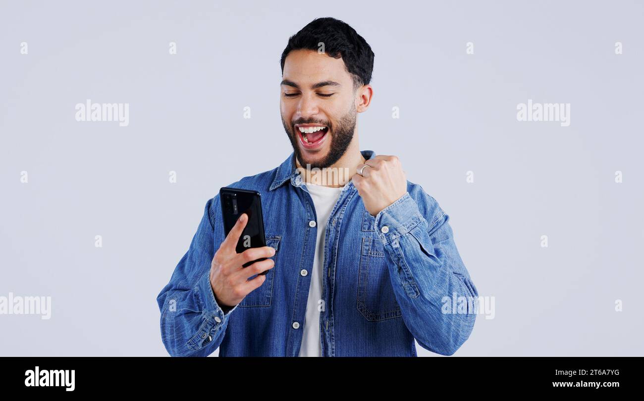Man, phone and excited with winner notification with surprise on ...