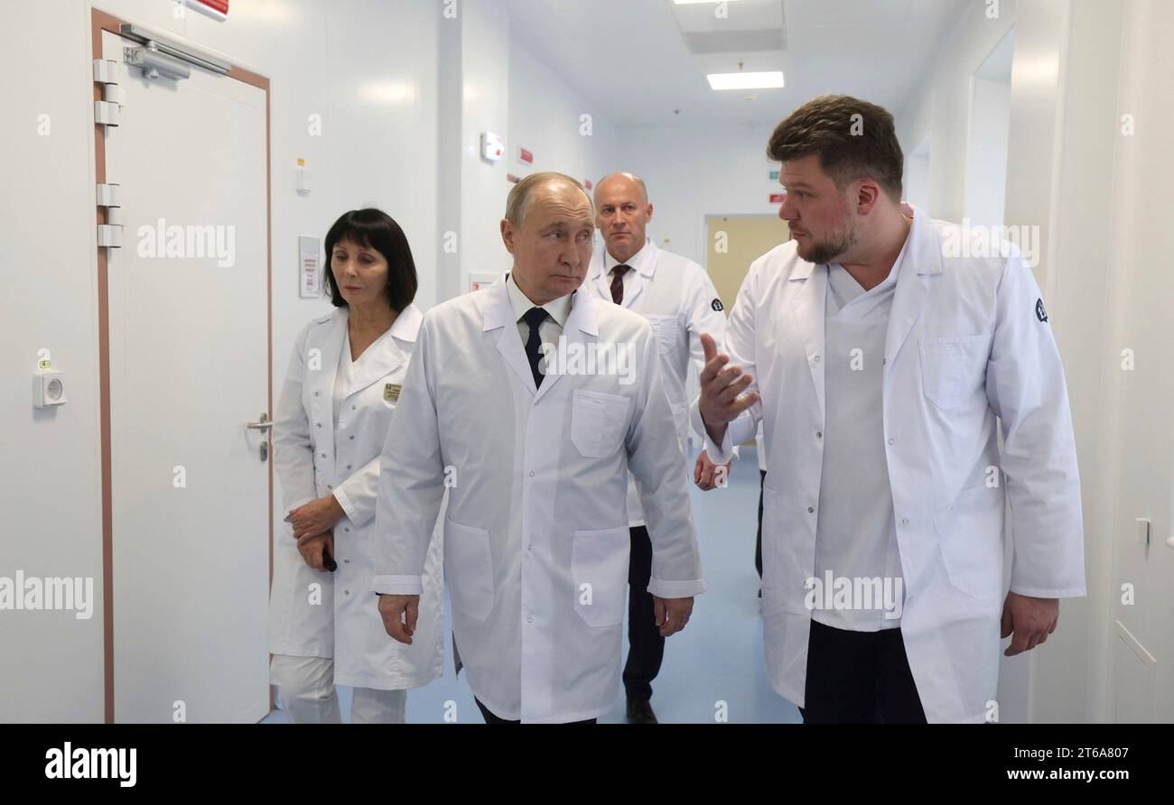 Moscow, Russia. 08th Nov, 2023. Russian President Vladimir Putin, center, wearing a lab coat, tours the advanced medical facilities of the Dmitry Rogachev National Research Center of Pediatric Hematology, Oncology and Immunology, November 8, 2023 outside Moscow, Russia. Standing from left: Director-General Galina Novichkova, President Vladimir Putin, and Deputy Healthcare Minister Viktor Fisenko. Credit: Gavriil Grigorov/Kremlin Pool/Alamy Live News Stock Photo