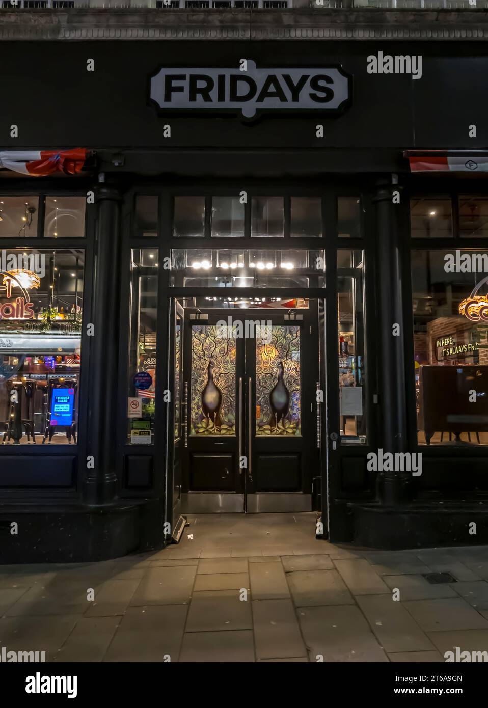 Entrance to FRIDAYS bar and restaurant at night, High Street, Lincoln