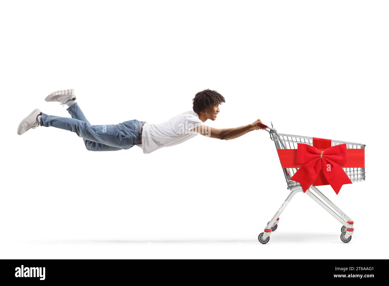 African american guy flying and holding onto the handle of a shopping