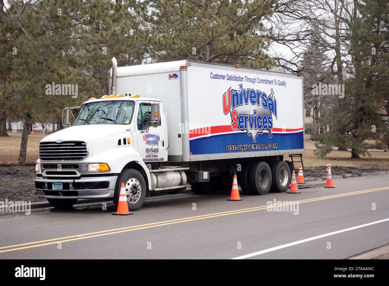 Universal Services cable truck providing support and supplies for laying underground conduit for housing electronic cable. St Paul Minnesota MN USA Stock Photo
