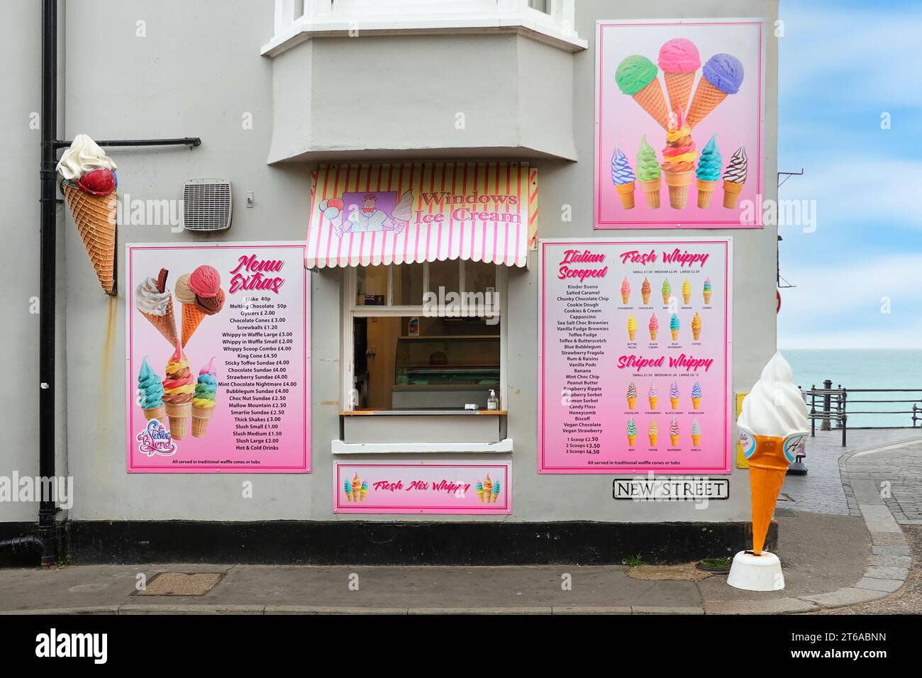 Cromer Windows Ice Cream Parlour shop front & serving hatch decorated pink wall mounted detailed lists of products at September 2023 prices Norfolk UK Stock Photo