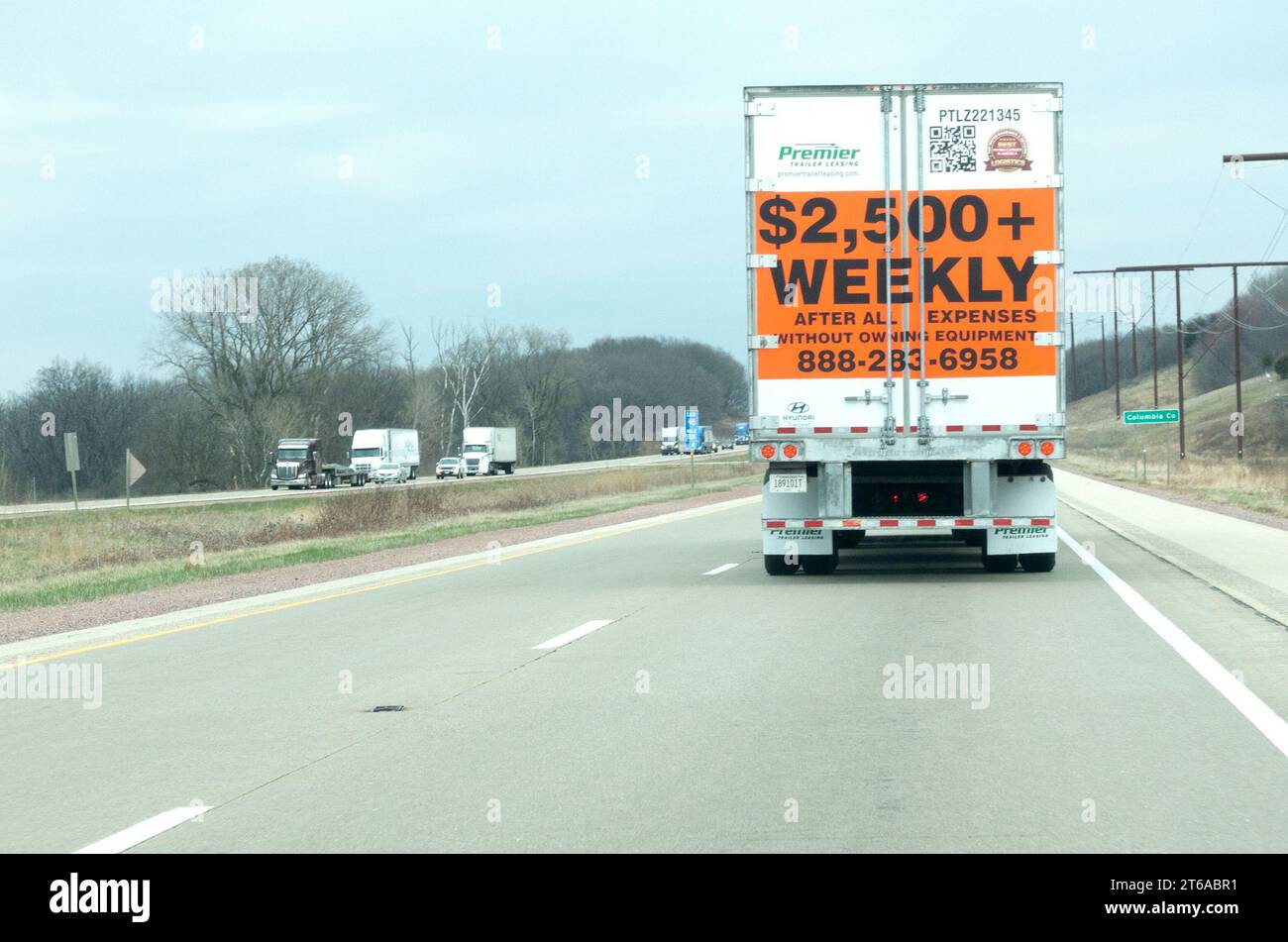 Truck advertising a driving job at $2,500+ a week on the back panel while driving on the freeway. Freeway 94 Wisconsin MN USA Stock Photo