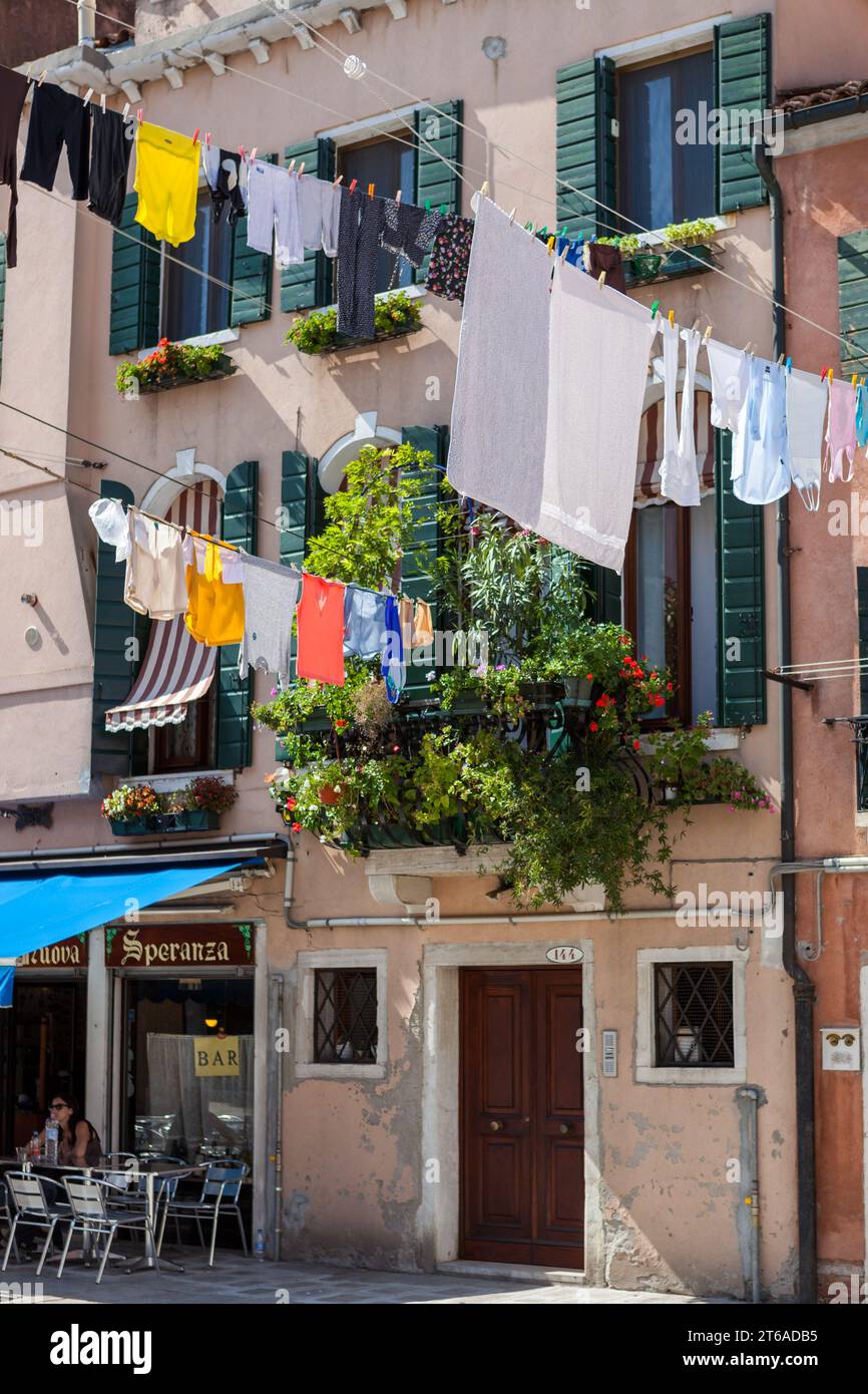 Clothes hanging on a clothesline on a street in Castello, Venice, Italy. Stock Photo