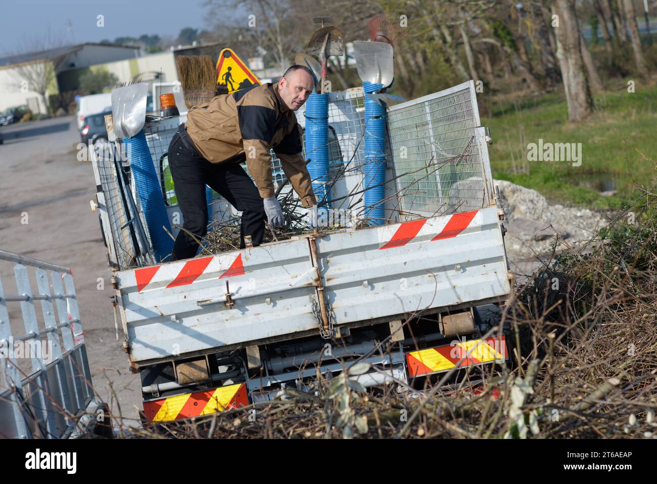 rubbish collector traveling on the lorry Stock Photo
