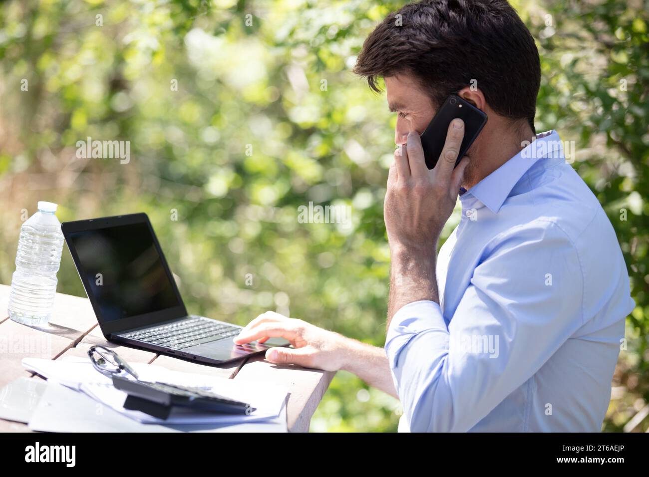man working on his computer outdoors Stock Photo