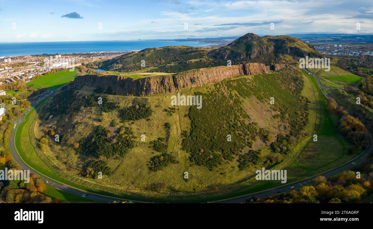 Aerial view of Salisbury Crags with Arthur’s Seat to rear  in Holyrood Park, Edinburgh, Scotland, UK Stock Photo