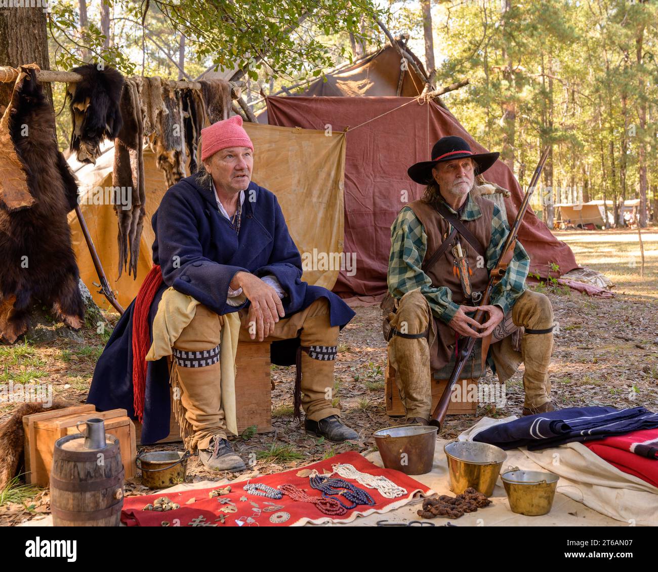 Two adult male actors portraying frontiersmen from the early 1800s in a campsite setting at a reenactment in Wetumpka Alabama, USA. Stock Photo