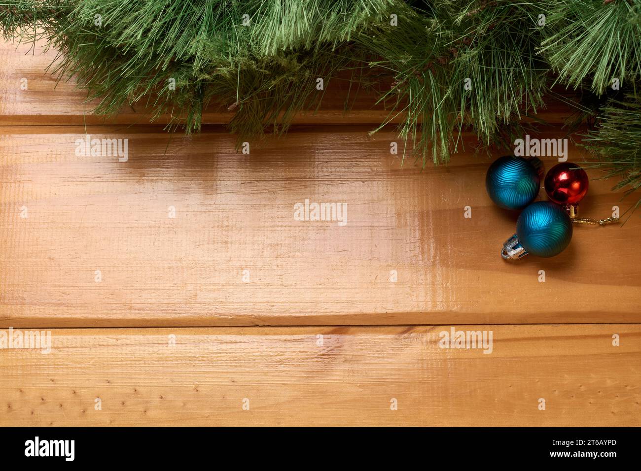 Top view of Christmas decoration on rustic wooden table. Christmas balls and tree on the table, background with copy space for text. Stock Photo