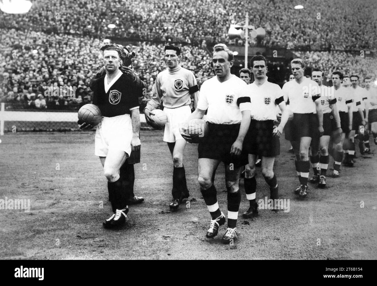 Billy Wright leads out the England team for his 100th cap followed by Ronnie Clayton and Ron Flowers.  With Bobby Evans and Bill Brown of Scotland. 11/4/59 Stock Photo