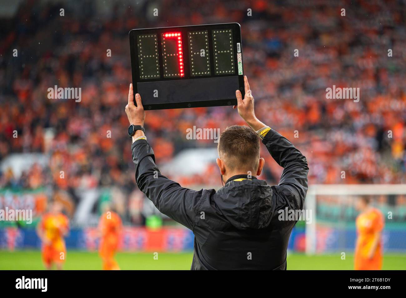 Technical referee shows added time during football match Stock Photo