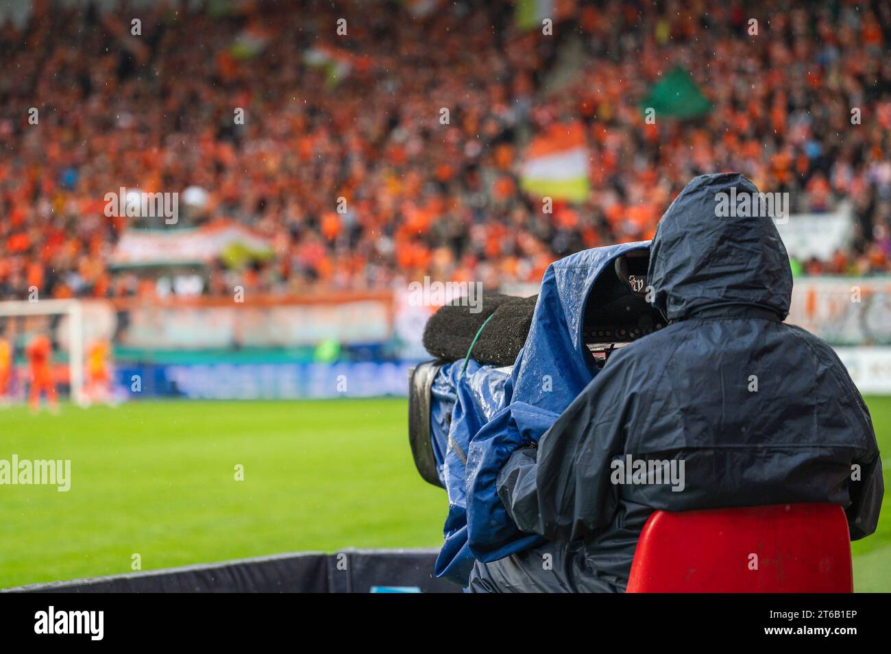 Cameraman near playing field during soccer match. Stock Photo