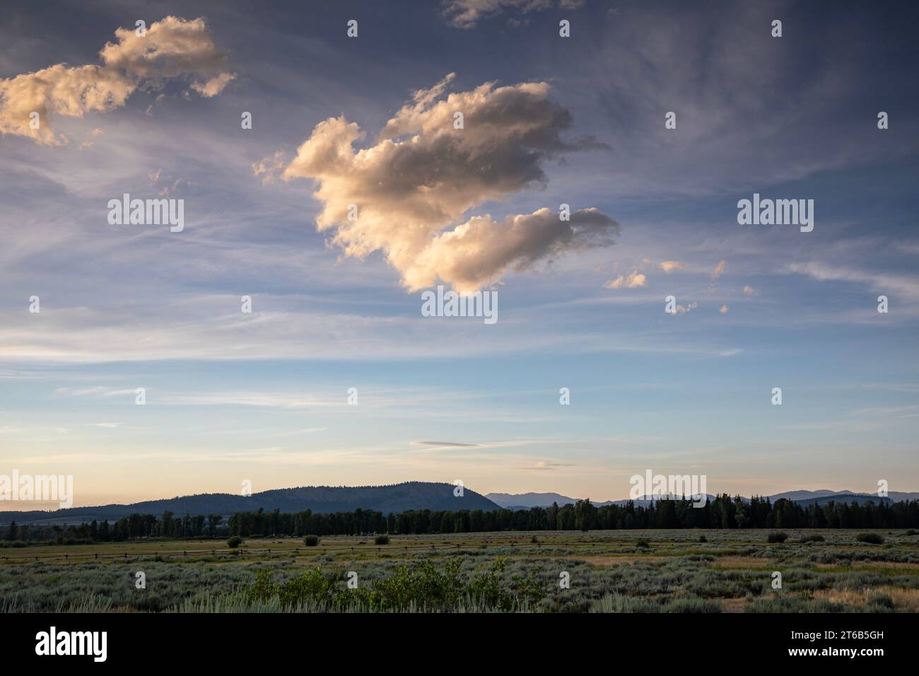 WY05767-00...WYOMING - Clouds at sunset over the Cunningham Cabin historical site in Grand Teton National Park. Stock Photo