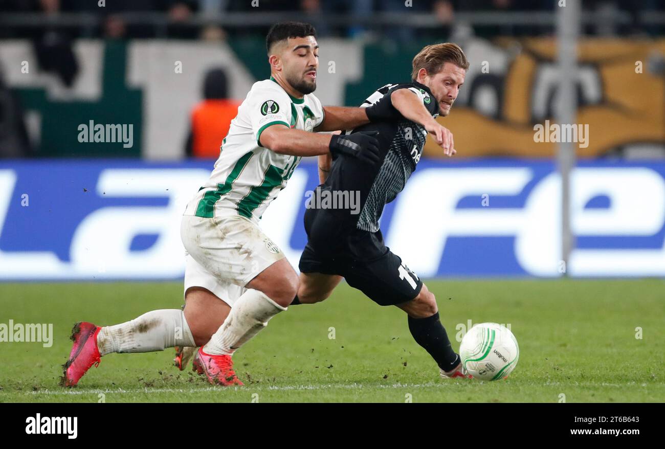 Budapest, Hungary. 09th Nov, 2023. Ferencvaros' Mohammad Abu Fani and Genk's Patrik Hrosovsky fight for the ball during a soccer game between Hungarian Ferencvarosi TC and Belgian soccer team KRC Genk, on Thursday 09 November 2023 in Budapest, Hungary, on day 4 of the group phase of the UEFA Conference League competition, in group F. BELGA PHOTO NIKOLA KRSTIC Credit: Belga News Agency/Alamy Live News Stock Photo