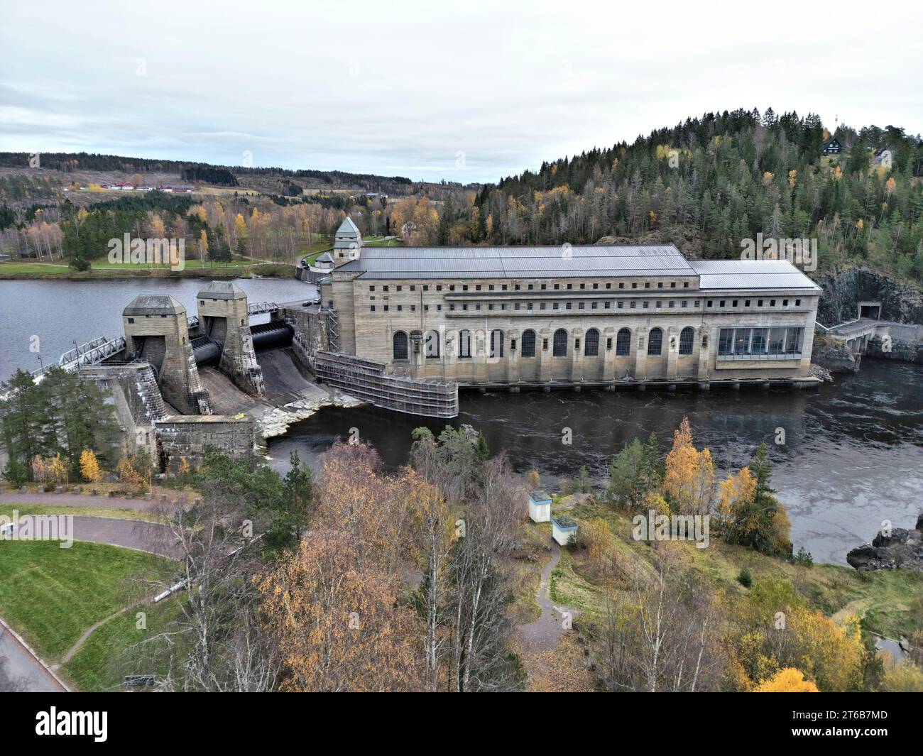 An expansive edifice with a waterfall cascading down its side and lush ...
