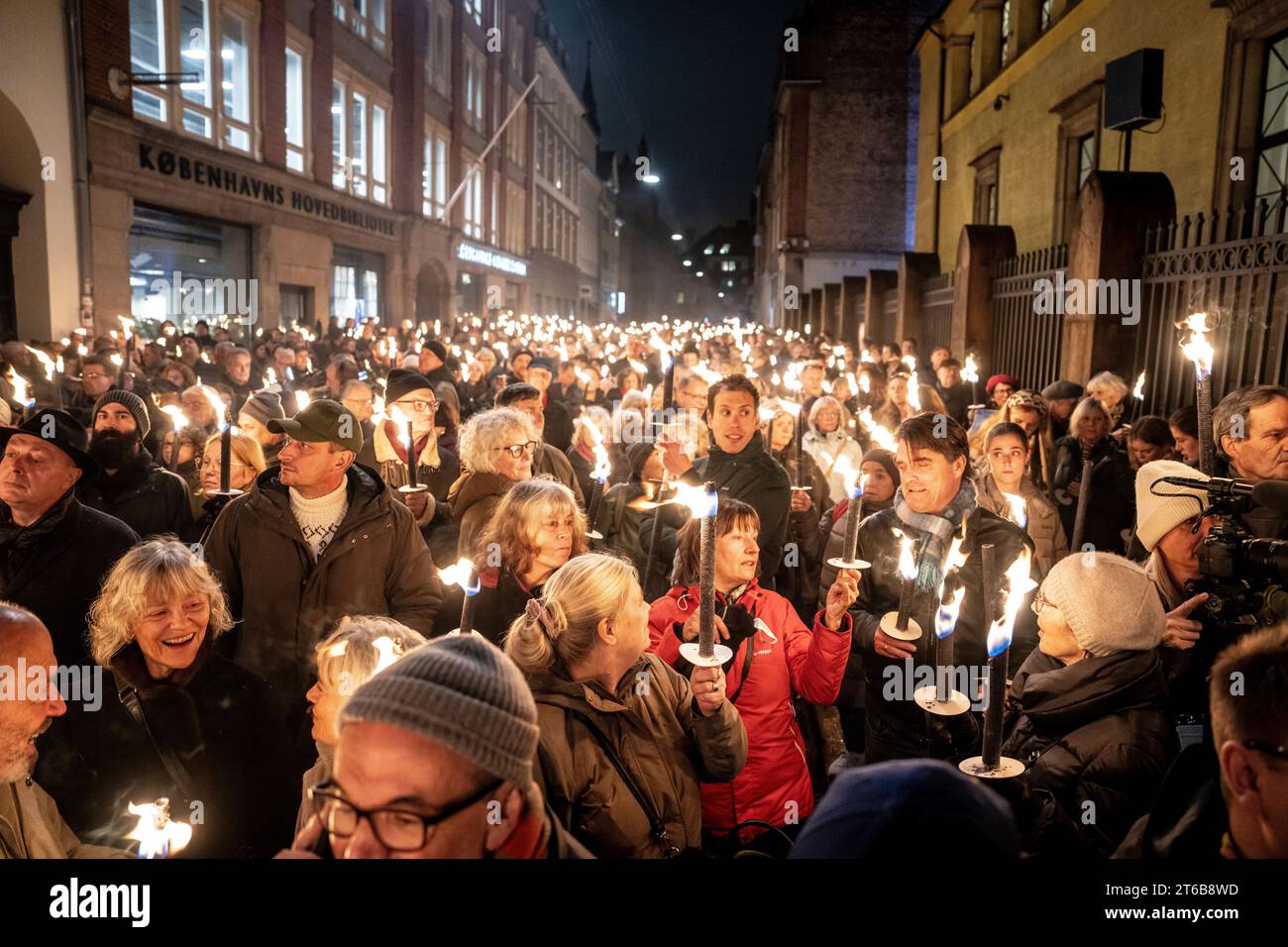 People participates in a torchlight procession arranged by the Jewish Society to mark the 85th anniversary of the Night of Broken Glass in Copenhagen Thursday November 9, 2023 Stock Photo