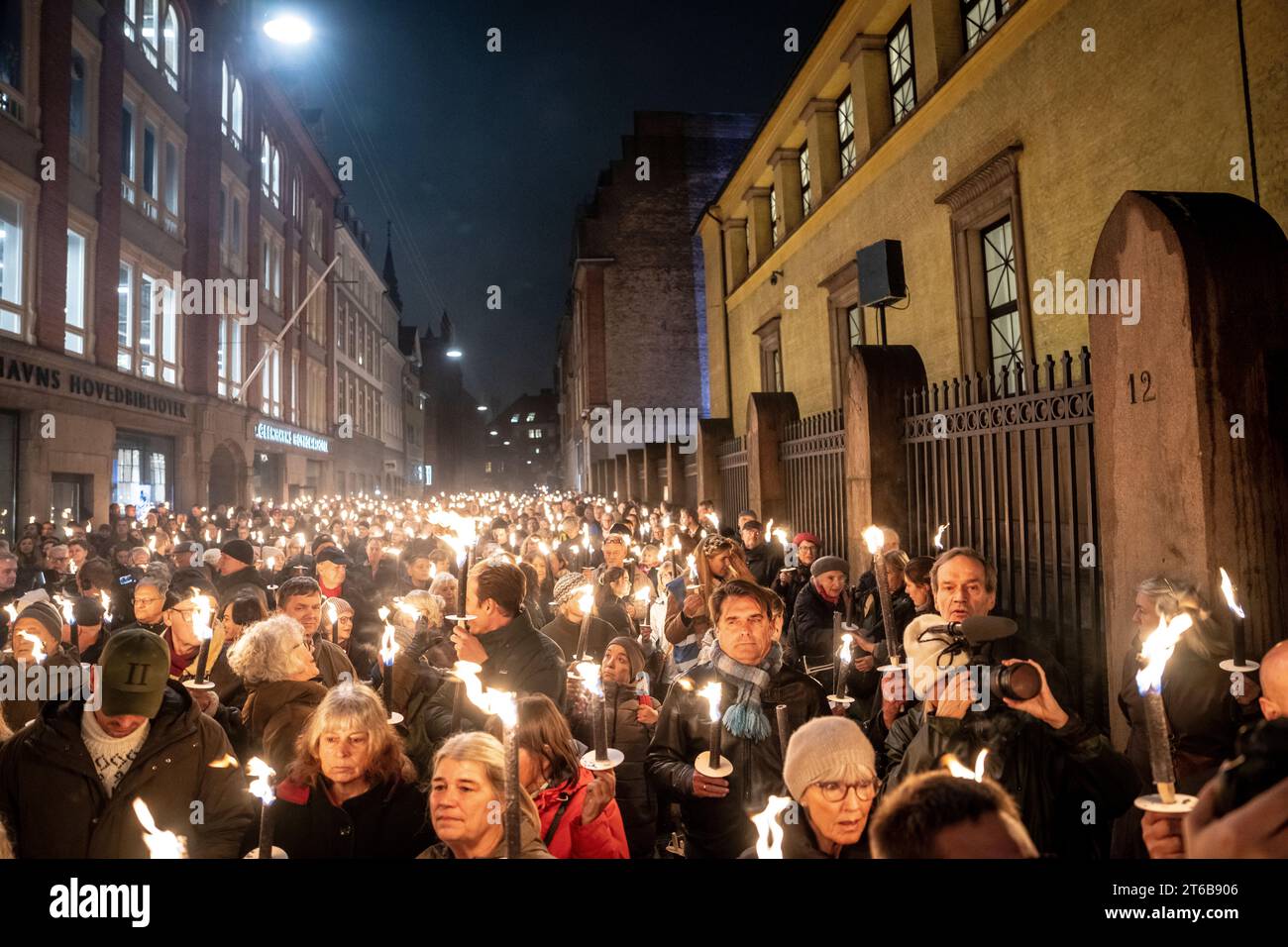 People participates in a torchlight procession arranged by the Jewish Society to mark the 85th anniversary of the Night of Broken Glass in Copenhagen Thursday November 9, 2023 Stock Photo