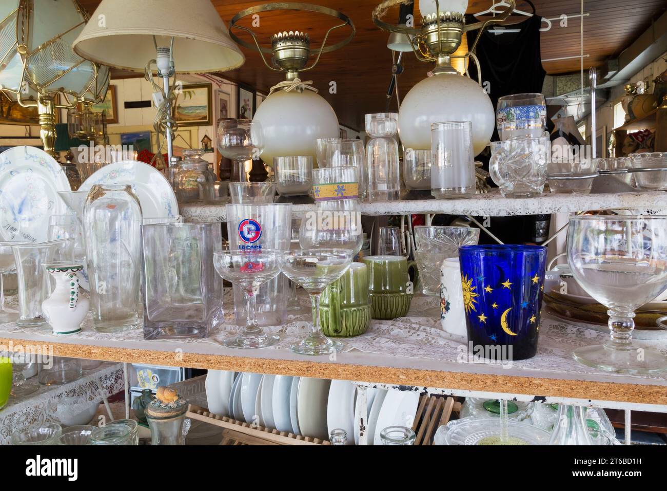 Drinking glasses, dinnerware and figurines for sale inside second hand
