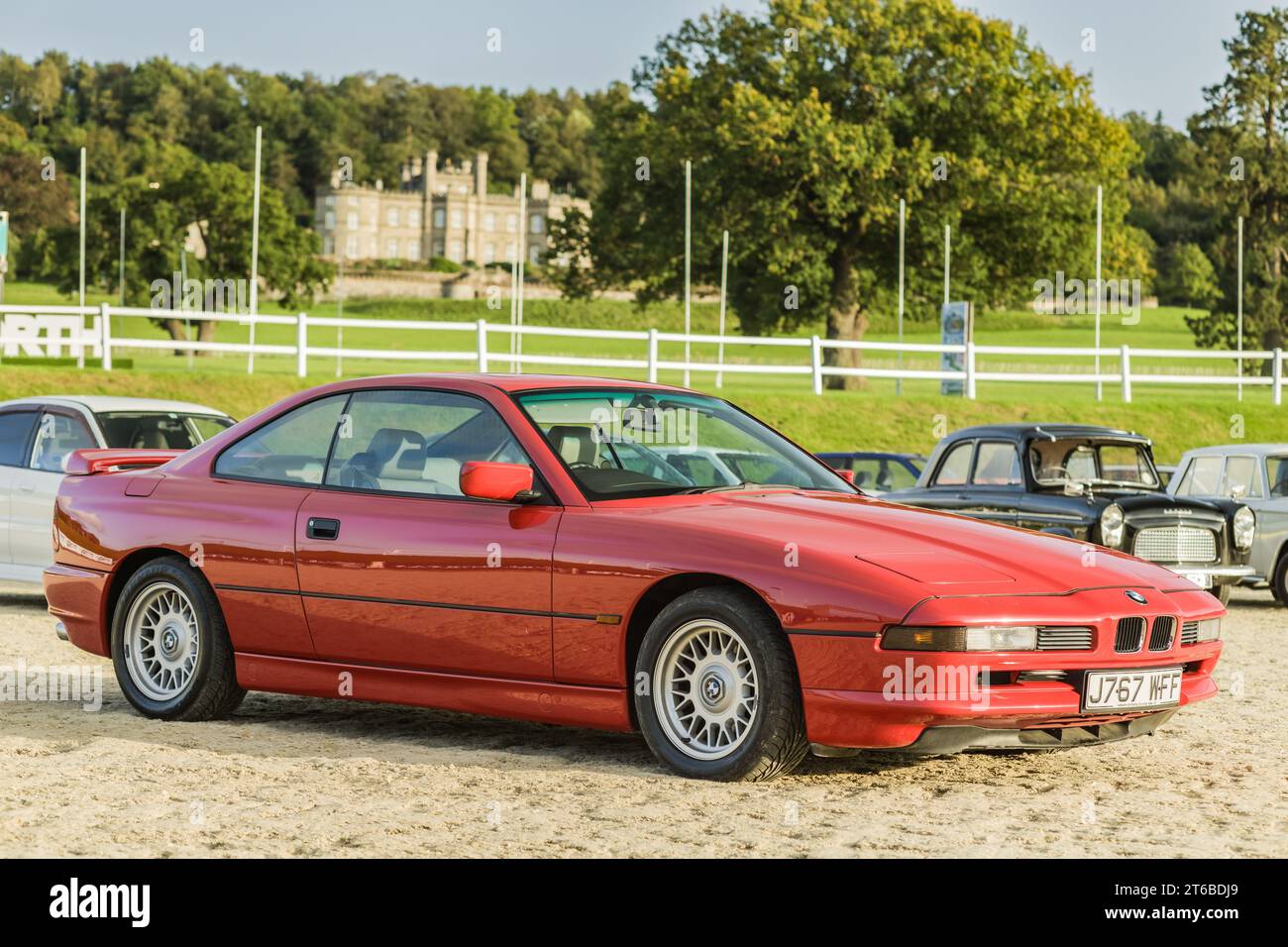 Chester, Cheshire, England, September 29th 2023. Red BMW 8 Series displayed at Bolesworth Castle, automotive lifestyle editorial illustration. Stock Photo