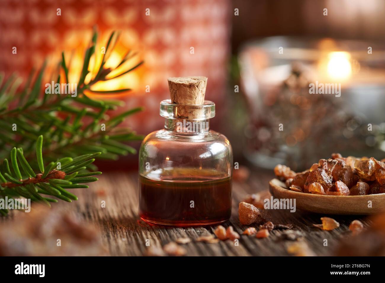 A bottle of myrrh essential oil with a candle and Christmas decoration Stock Photo