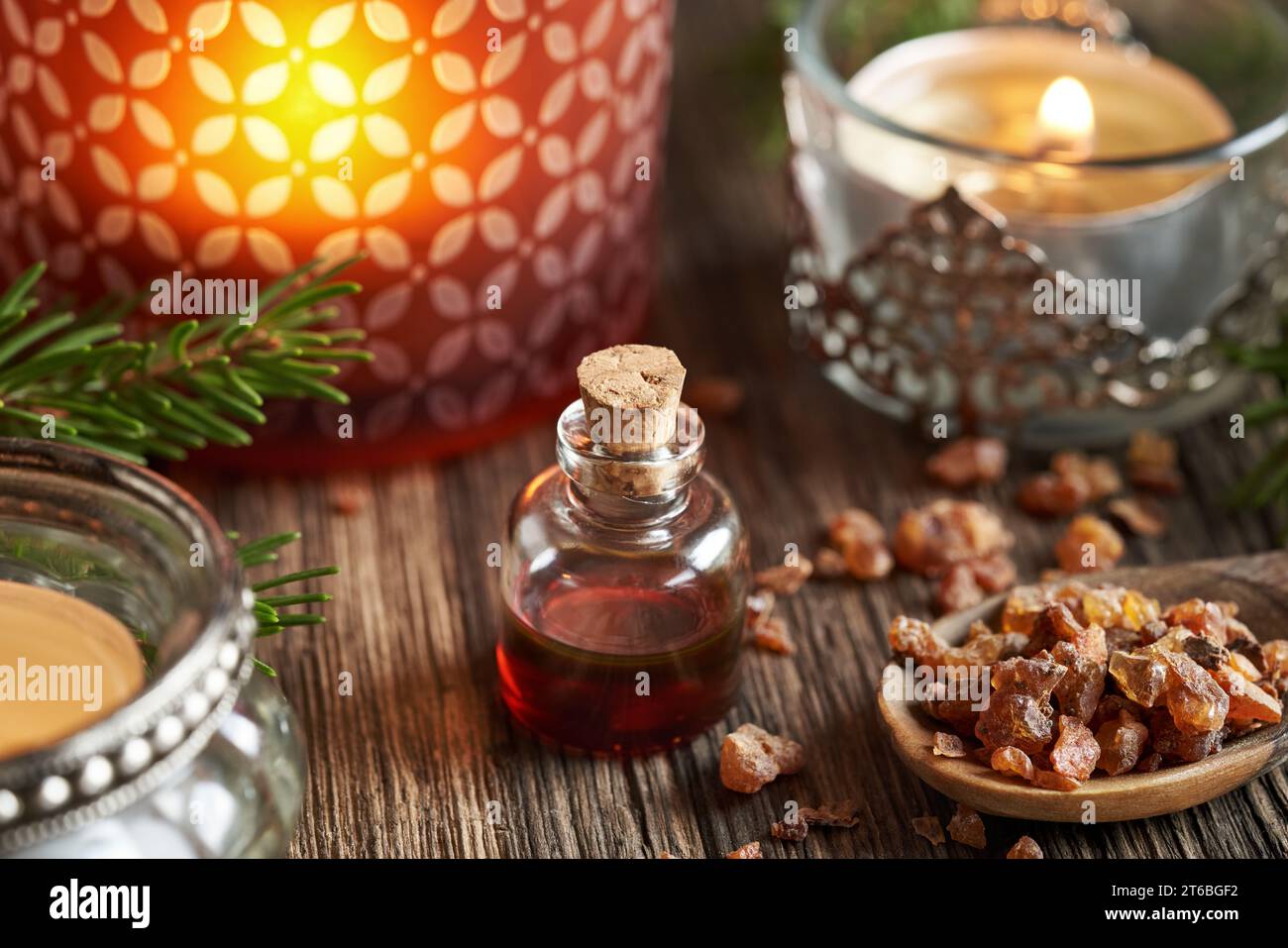 A bottle of myrrh essential oil with Christmas candles Stock Photo