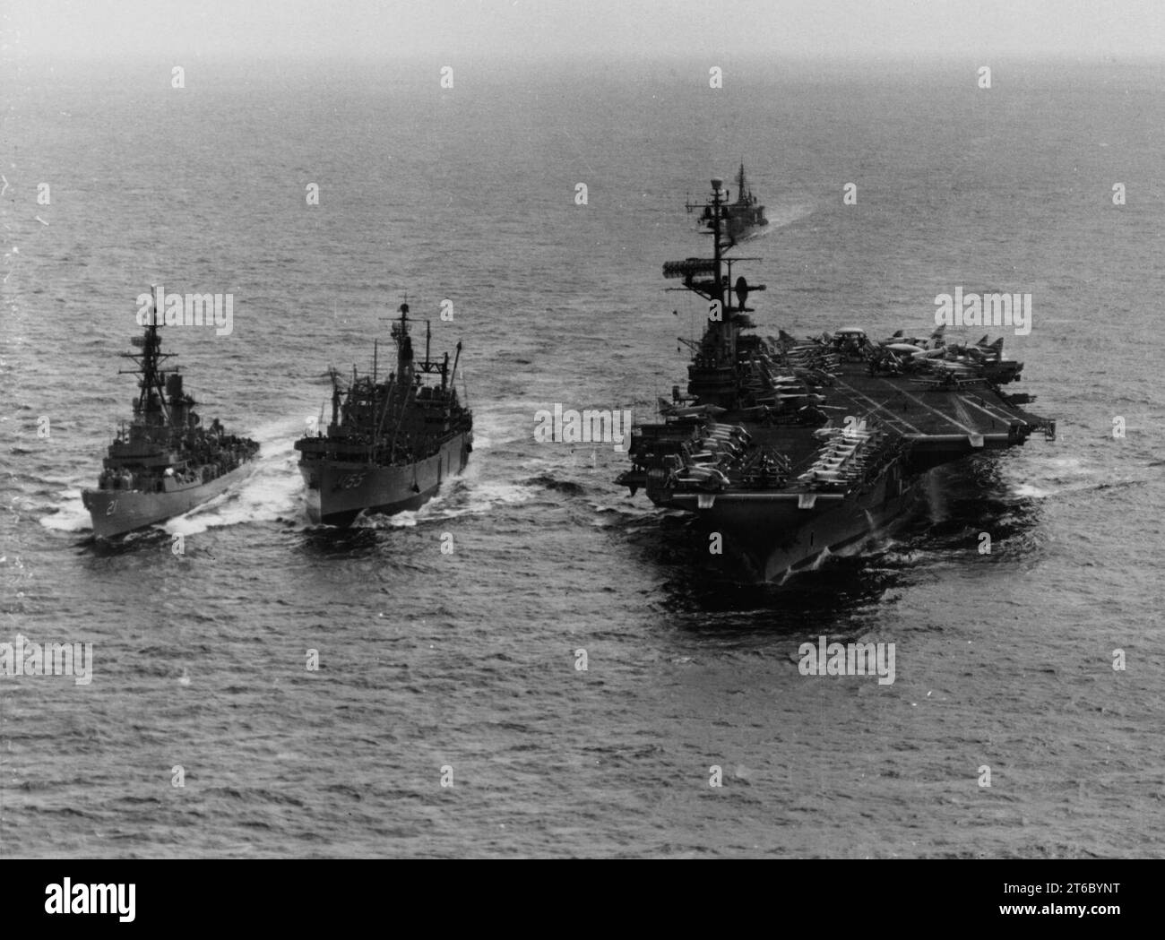 USS Aludra (AF-55) replenishes USS Coral Sea (CVA-43) and USS Cochrane (DDG-21) off Vietnam on 15 May 1965 Stock Photo