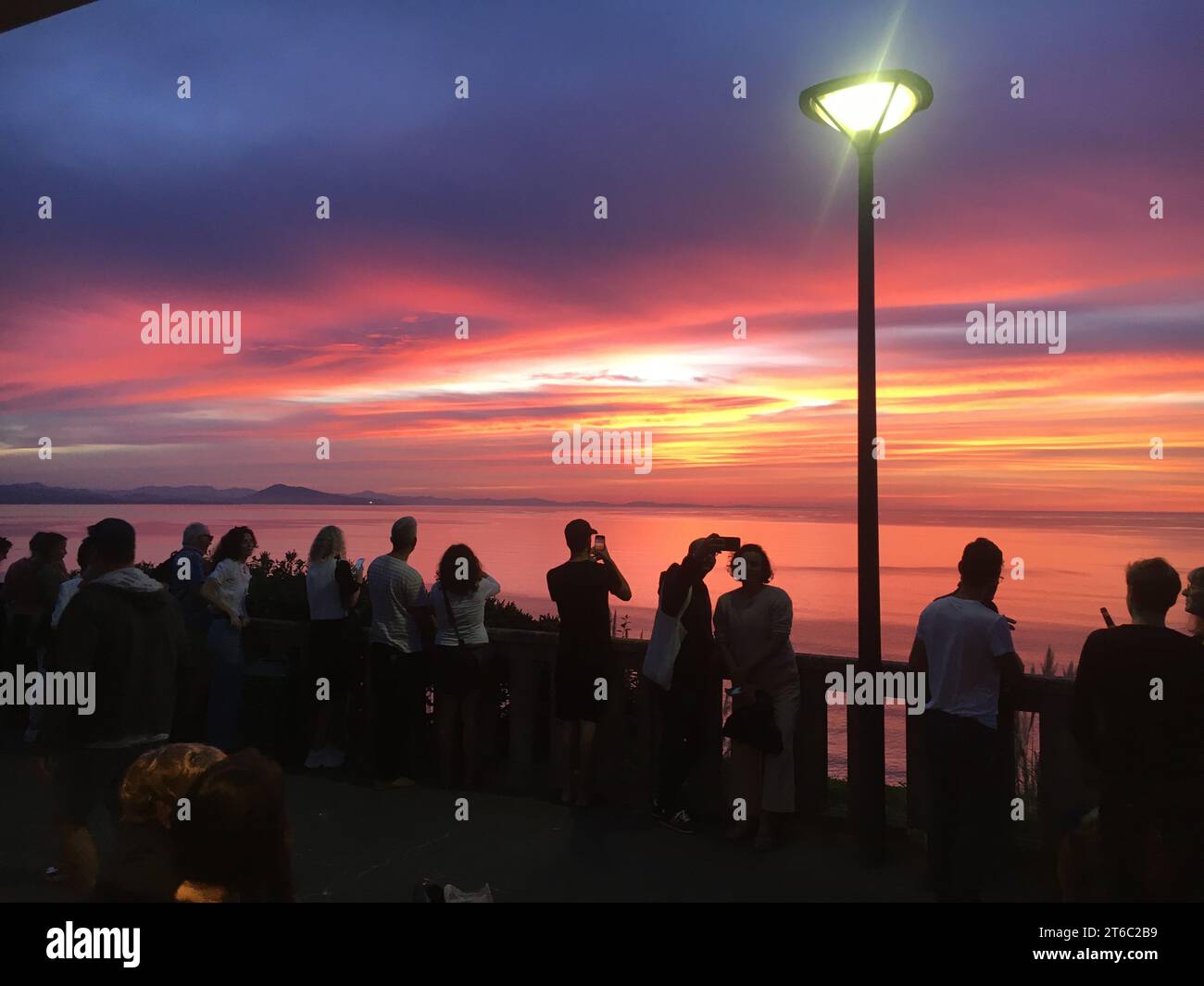 People front of the sunset Stock Photo - Alamy