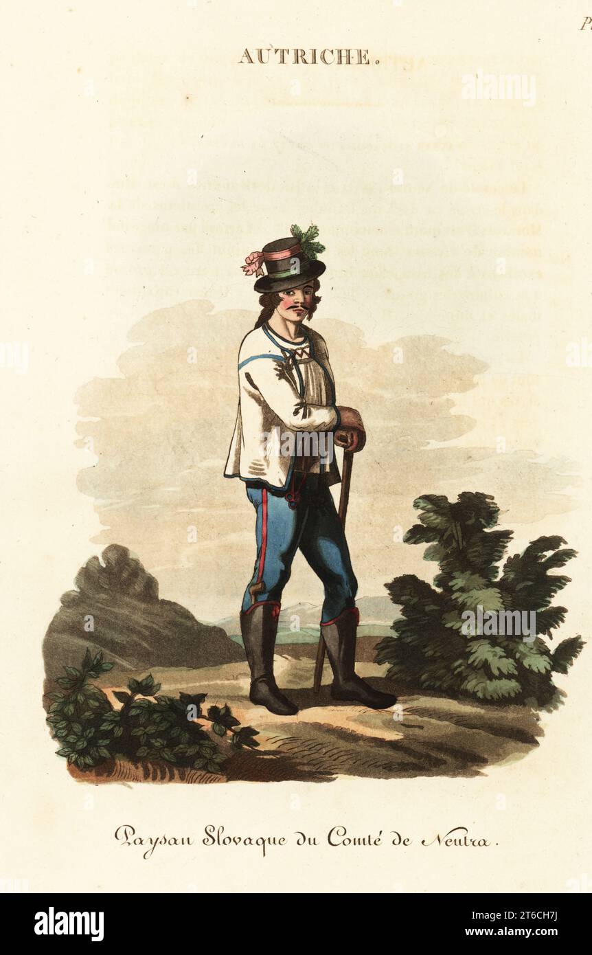 Slav youth of Nitra Country, Kingdom of Hungary (Slovakia), 18th century. He wears a holiday dress, hat decked with ribbons, embroidered jacket, blue pantaloons, Hungarian half-boots with a tobacco pipe in the right one. Schlavonian man of the County of Neutra, Paysan Slovaque du Comte de Neutra. Handcoloured copperplate engraving after an illustration by William Alexander from J-B. Eyries L'Autriche: Costumes, Moeurs et Usages des Autrichiens, Austria: Costumes, Manners and Mores of the Austrians, Librairie de Gide Fils, Paris, 1823. Jean-Baptiste Eyries (1767-1846) was a French geographer, a Stock Photo