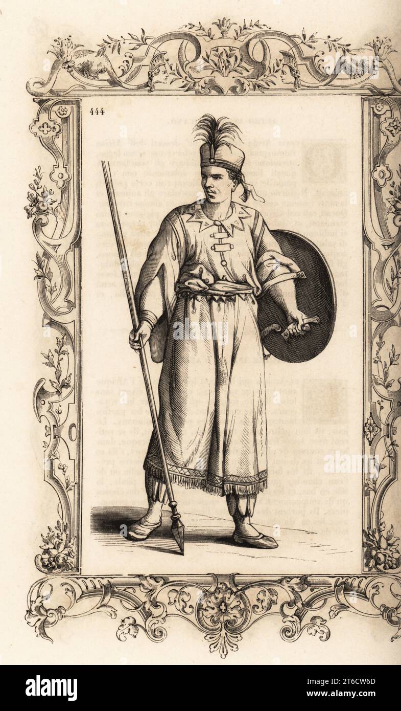 Warrior of the African kingdom of Djebel or Giabea. He carries a targe or round shield and a poisoned lance or assegai. Costume de Djebel, Royaume dAfrique. Within a decorative frame engraved by H. Catenacci and Fellmann. Woodblock engraving by Gerard Seguin and E.F. Huyot after a woodcut by Christoph Krieger from Cesare Vecellios 16th century Costumes anciens et modernes, Habiti antichi et moderni di tutto il mondo, Firman Didot Ferris Fils, Paris, 1859-1860. Stock Photo