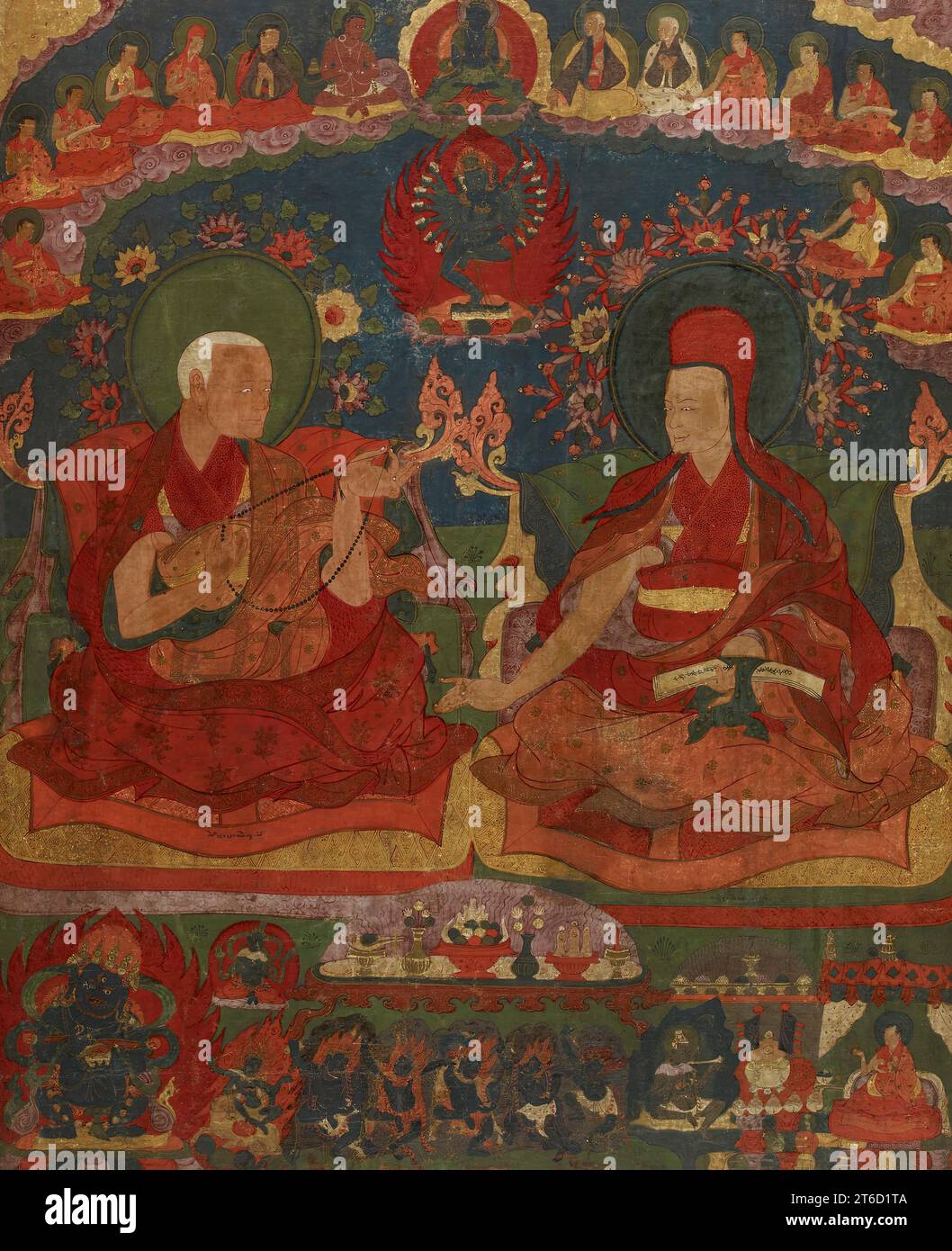 Abbots of the Ngor Monastery, late 16th century. The first two abbots of the Ngor Monastery in central Tibet, the older Sempa Chenpo and the younger Jamyang Sherab Gyatsho, engage in a lively conversation. They may be discussing the teachings of the &quot;Hevajra Tantra&quot;: the wrathful deity Hevajra, united with his female partner, occupies the space between their flowered halos. Above Hevajra is the Buddha Vajradhara, the ultimate source of the tantra&#x2019;s teachings, surrounded by members of the teaching lineage. The fifth figure on the left wears a red hat identical to that of the yo Stock Photo
