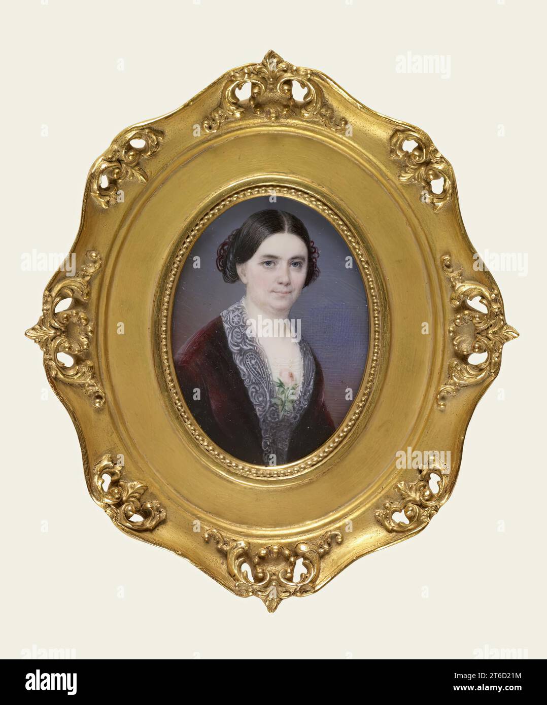 Lady in a red dress, c1850. Waist-length portrait of a woman with smooth black hair, wearing a wine-red velvet dress with low cut lace yoke. This miniature reputedly was taken from the pocket of a dead officer on a Southern battlefield of the Civil War. Stock Photo