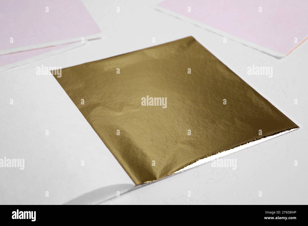 Edible gold leaf sheet on white background, closeup Stock Photo Alamy
