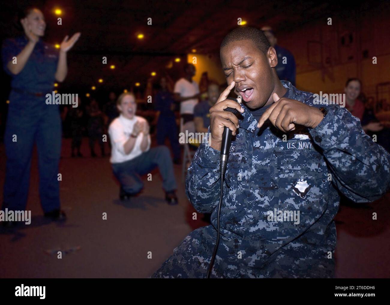USS Dwight D. Eisenhower sailor sings during karaoke night 120318 Stock ...
