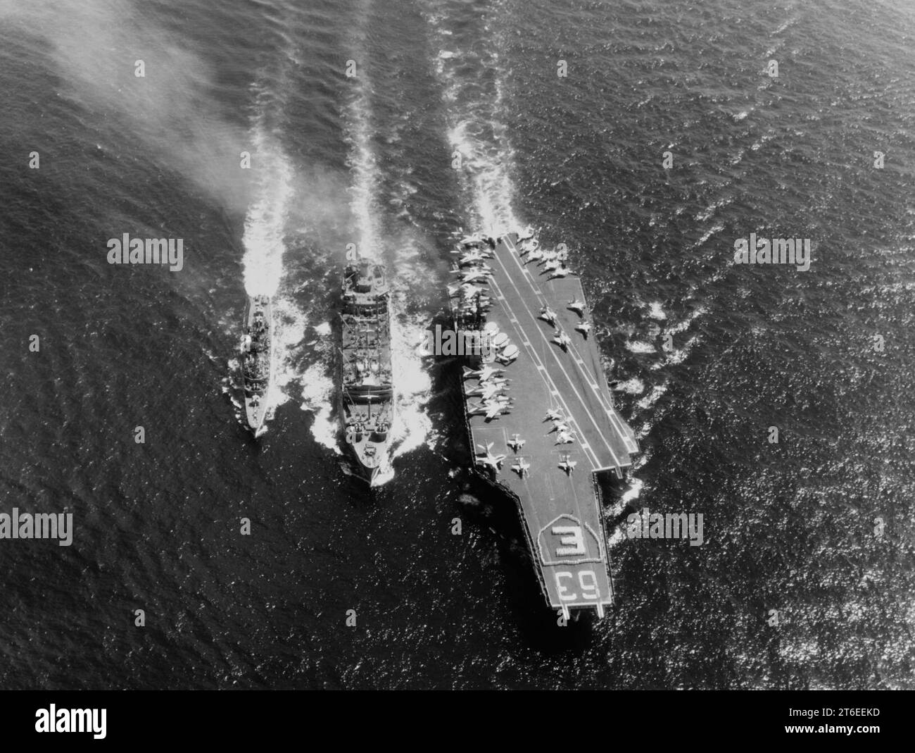 USS Kitty Hawk (CVA-63) and USS Turner Joy (DD-951) refueling from USS Kawishiwi (AO-146) on 23 April 1964 Stock Photo