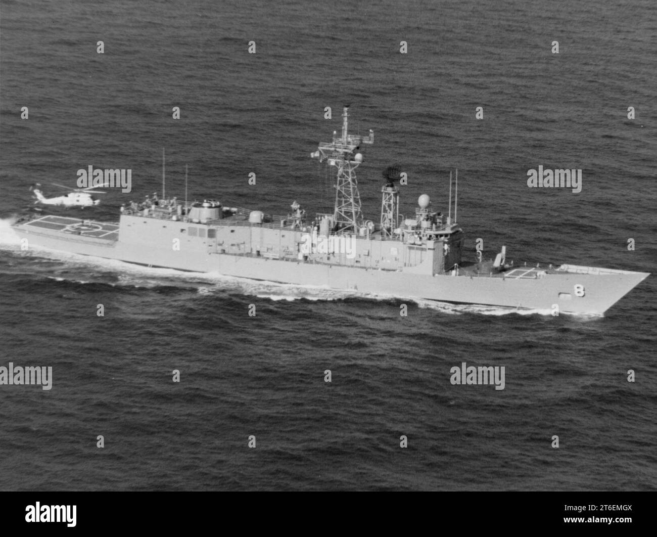 USS McInerney (FFG8) underway at sea, with a SH60B Seahawk over her