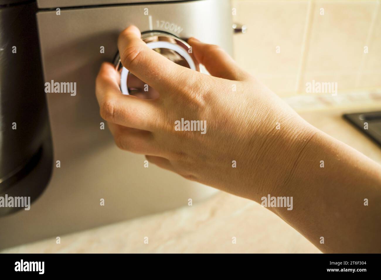 hand using. Girl Adjusting Temperature Of Microwave Oven.Using