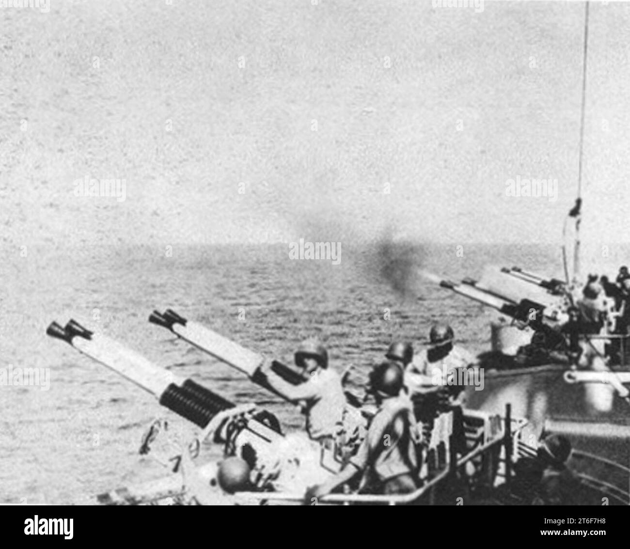 USS Quincy (CA-71) firing 40 mm guns in July 1952 Stock Photo