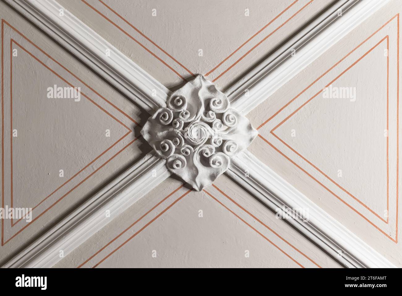 White gypsum bas-relief ceiling design details and red lines over beige background. Classic architecture abstract template, Gothic style Stock Photo