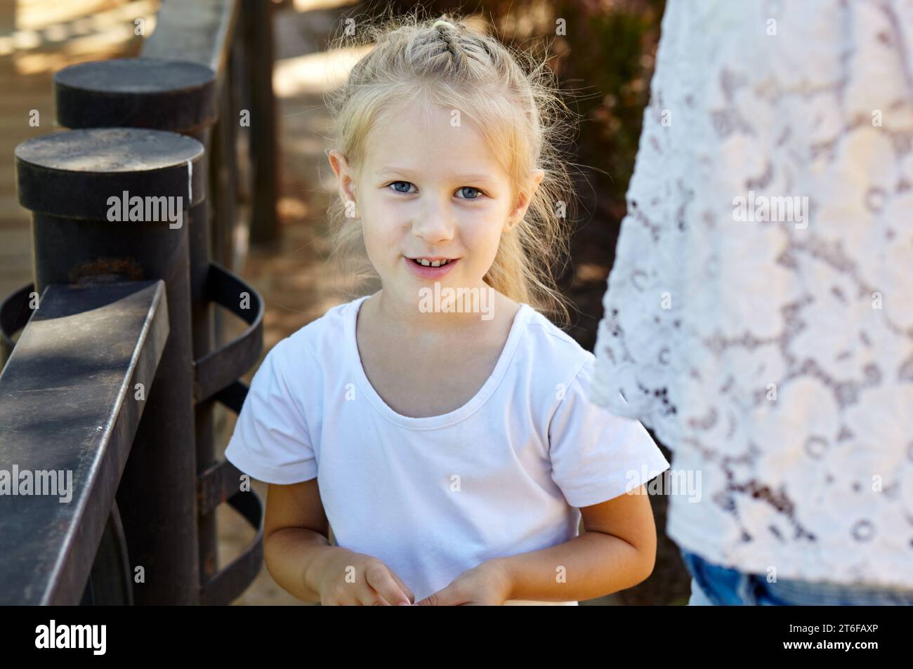 Mother and daughter walk in the summer city park. Childhood, leisure and people concept - happy family rest on nature and have a good time Stock Photo