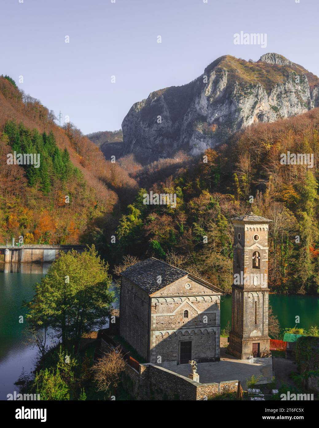 Isola Santa village, church, dam and lake in autumn. Apuan Alps in the background. Garfagnana, Tuscany region, Italy. Stock Photo