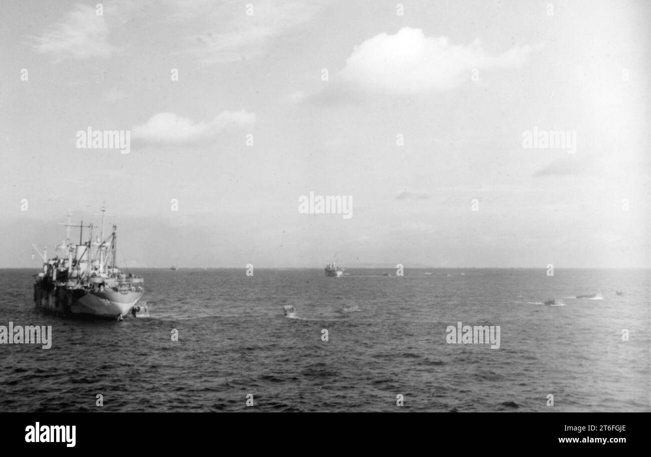 USS Sandoval (APA-194) with landing craft off Iwo Jima, 19 February ...