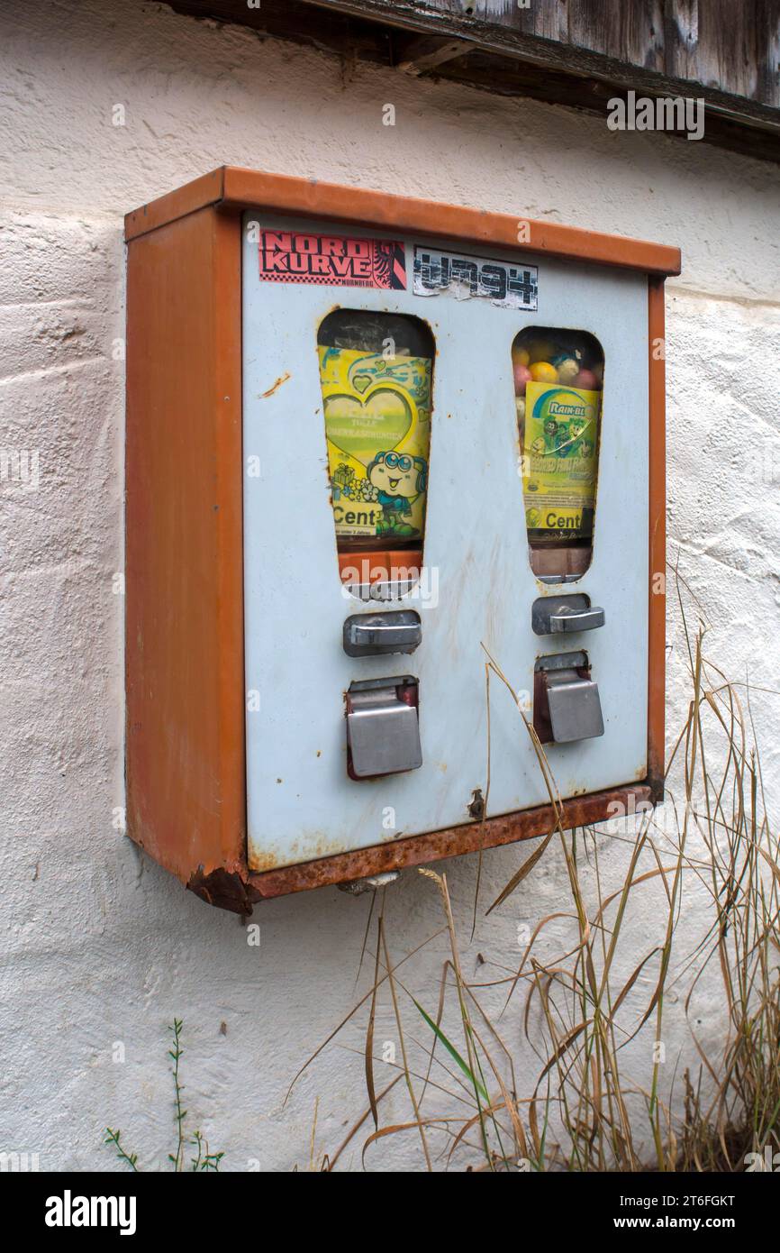 Chewing gum vending machine from the 1950s on a house wall, Franconia