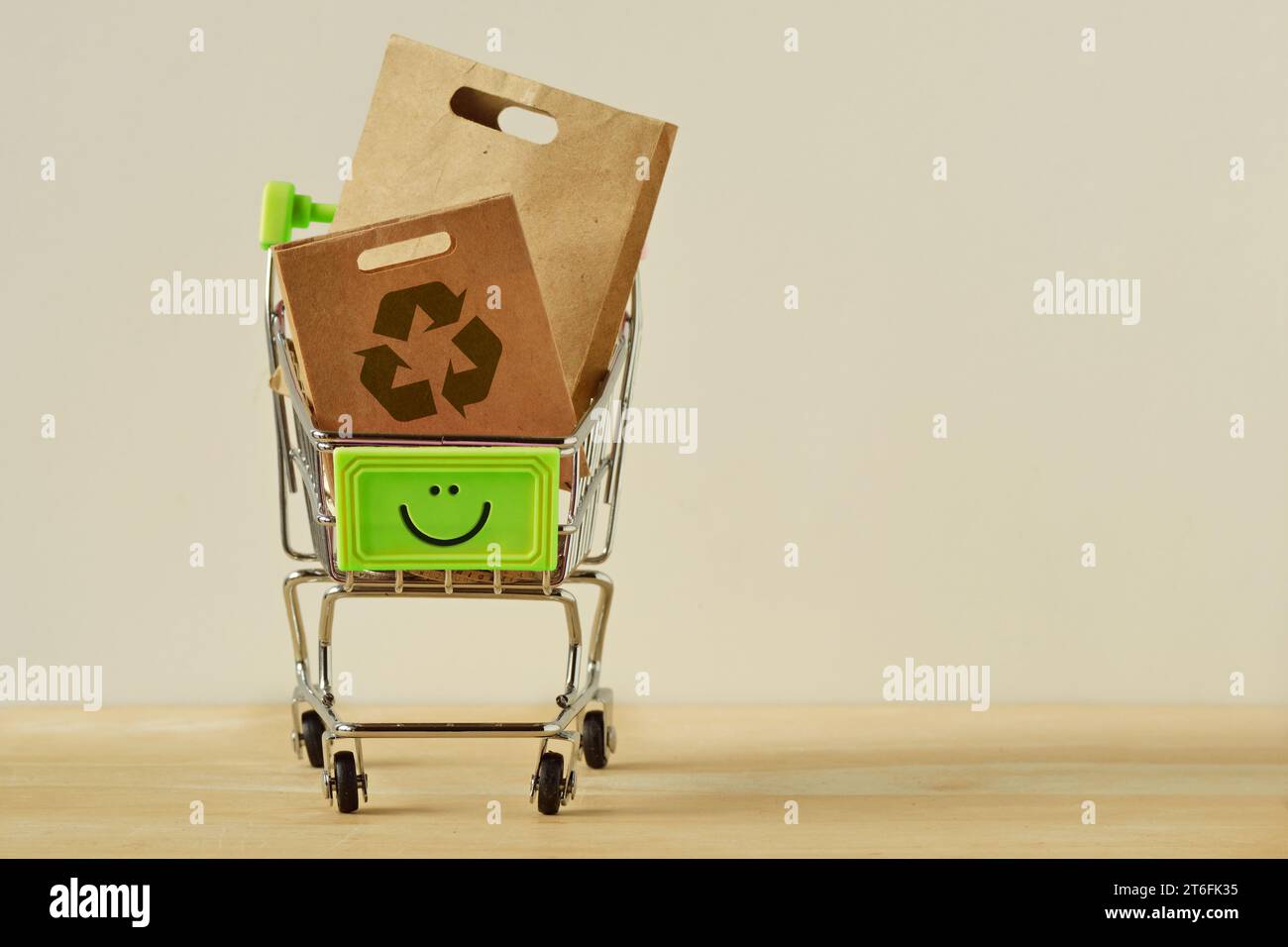 Shopping cart with happy face and paper shopping bags with recycle