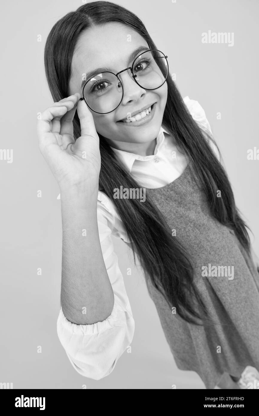 Portrait of teenager child in glasses. Kid at eye sight test. Girl holding eyeglasses and looking at camera. Vision, eyesight measurement for school c Stock Photo
