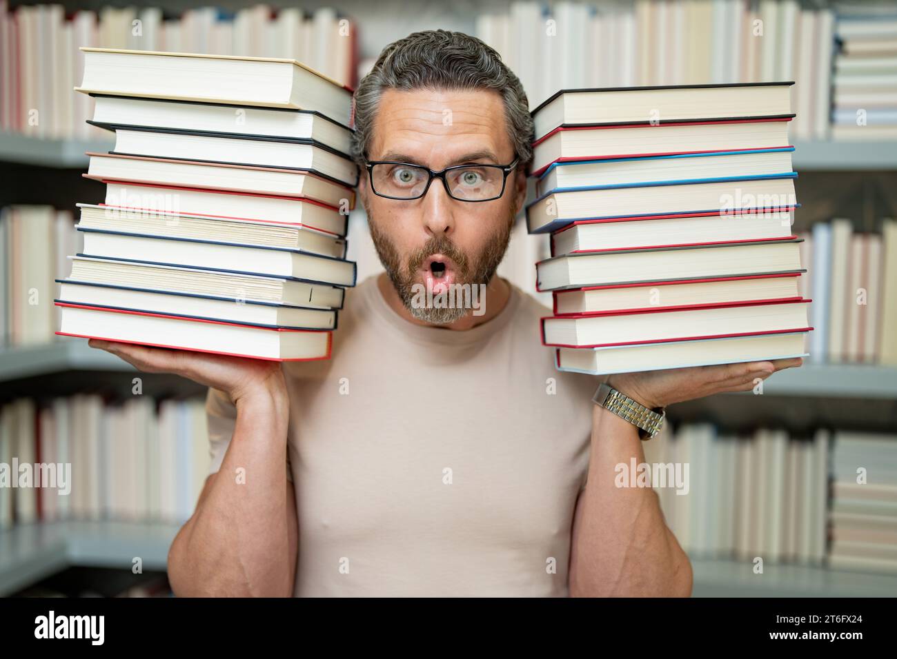 Teachers Day. Good teacher. Tutor at classroom. Man teacher with books in classroom. Knowledge and education concept. Funny teacher hold many books at Stock Photo