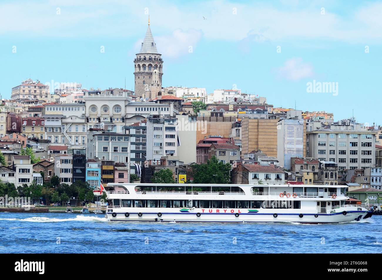 Istanbul, Türkiye. Ferry ship on the Golden Horn with a view of the Gala Tower Stock Photo