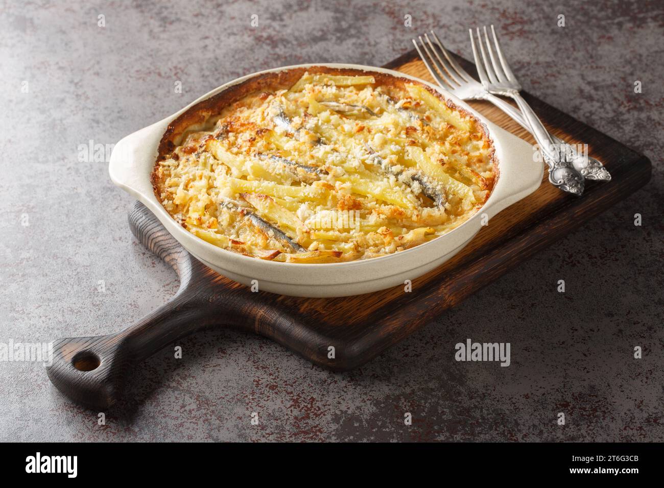 Janssons frestelse or Jansson's temptation is a creamy potato casserole traditionally served at Christmas in Sweden closeup on the baking dish on the Stock Photo